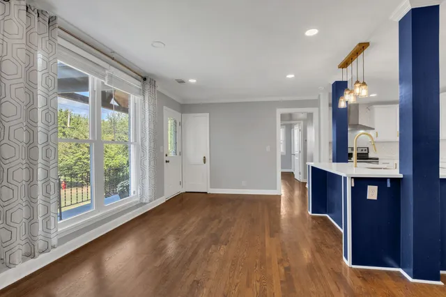 a view of kitchen and hall with wooden floor