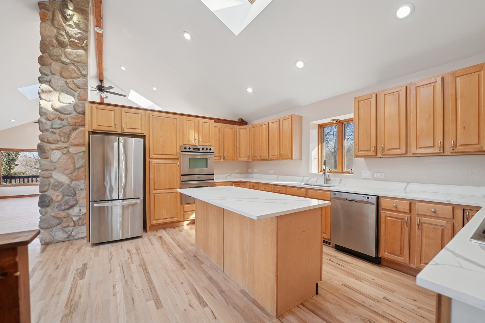 120 Old Barrington Road North Barrington, IL 60010 - Photo 10 of 31 a kitchen with stainless steel appliances granite countertop a refrigerator a sink dishwasher a stove and white countertops with wooden floor