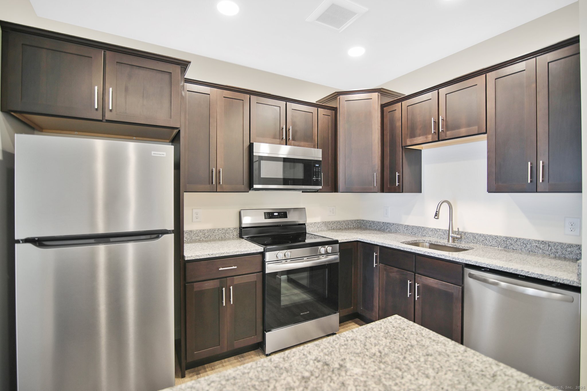 280 Salmon Brook Street, Unit 6114A Granby, CT 06035 - Photo 11 of 34 a kitchen with stainless steel appliances granite countertop a refrigerator stove a sink dishwasher and microwave
