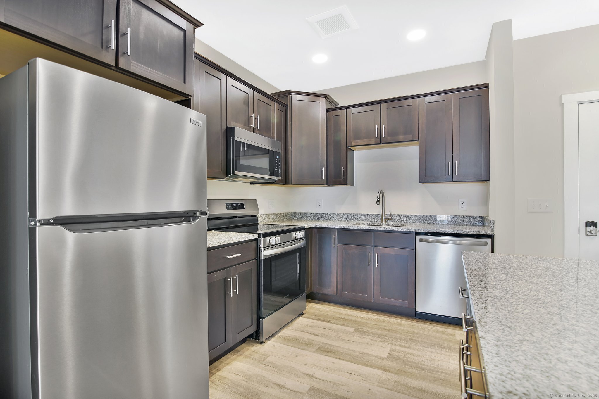 280 Salmon Brook Street, Unit 6114A Granby, CT 06035 - Photo 10 of 34 a kitchen with stainless steel appliances granite countertop a refrigerator a stove and a sink