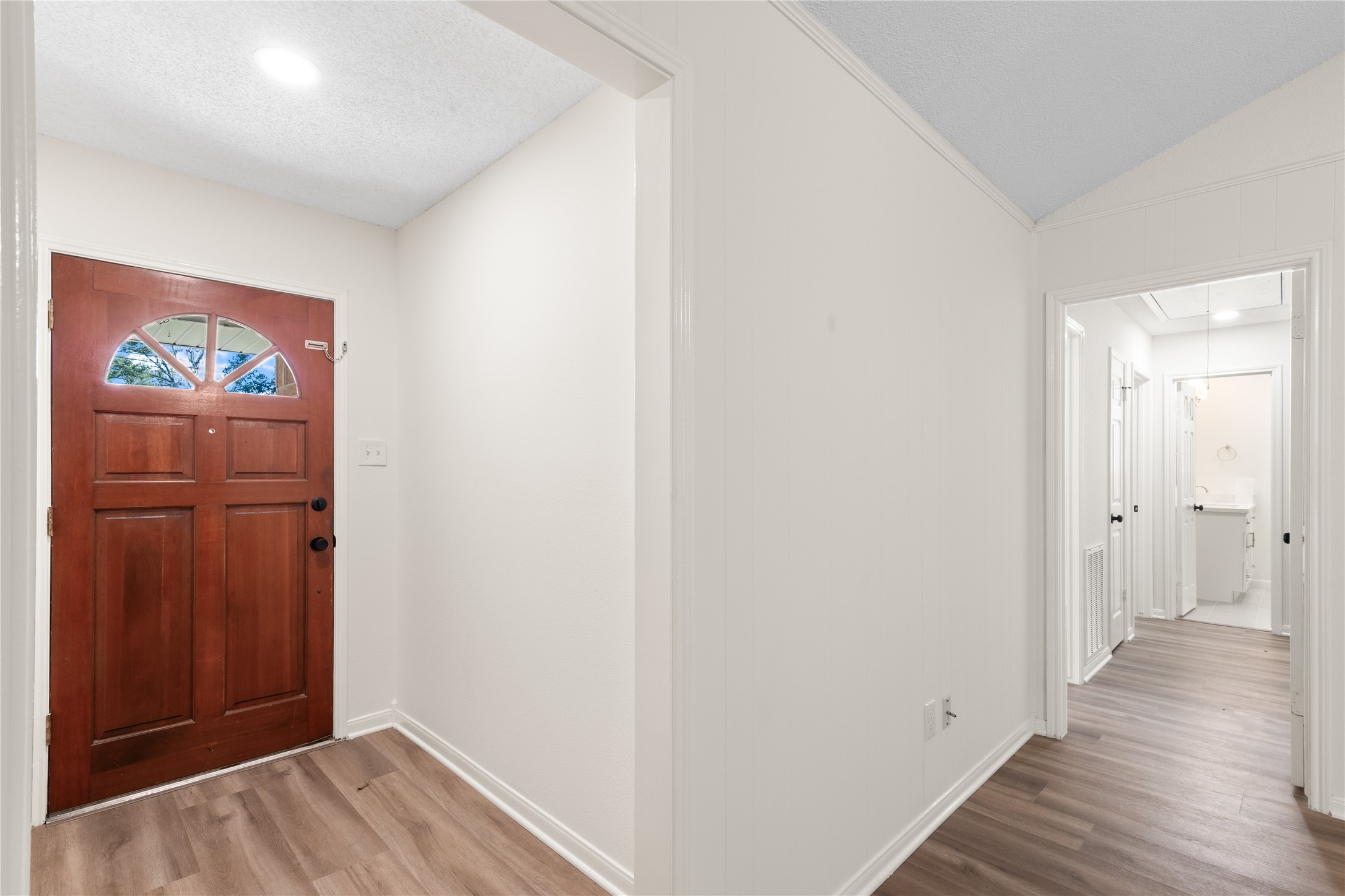 907 Avenue B Sweeny, TX 77480 - Photo 3 of 23 a view of a hallway with wooden floor