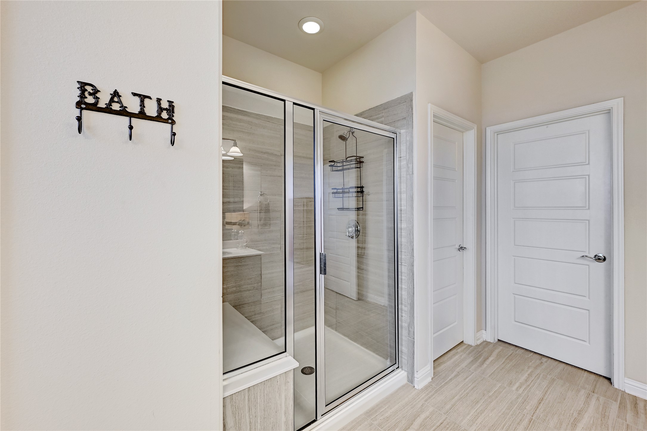6814 East Riverside Drive, Unit 64 Austin, TX 78741 - Photo 16 of 17 Modern bathroom featuring a spacious glass-enclosed shower with contemporary tilework and light-toned flooring.