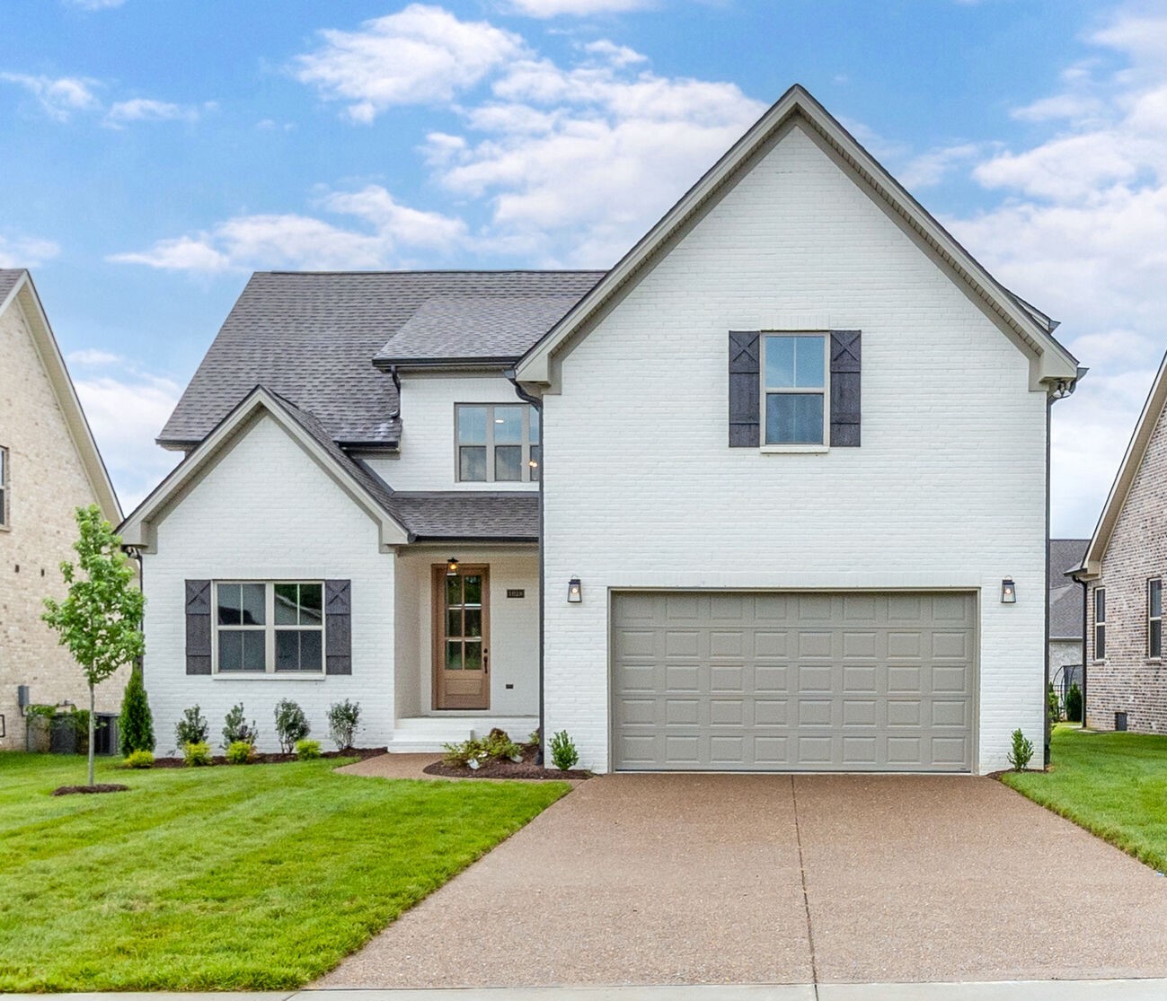 1028 Gadwall Lane Spring Hill, TN 37174 - Photo 1 of 40 a front view of a house with a garden and yard