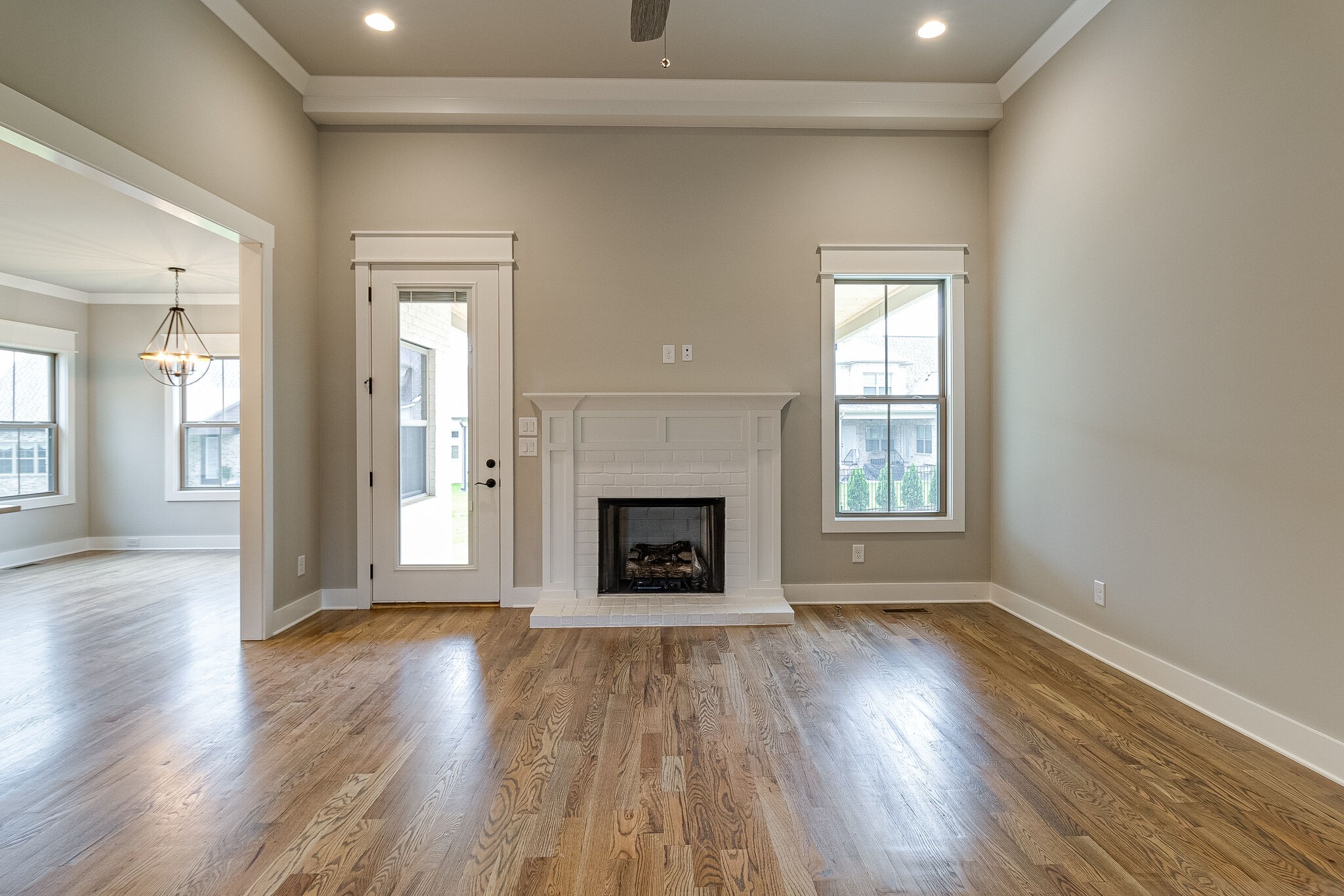 1028 Gadwall Lane Spring Hill, TN 37174 - Photo 12 of 40 an empty room with wooden floor fireplace and windows