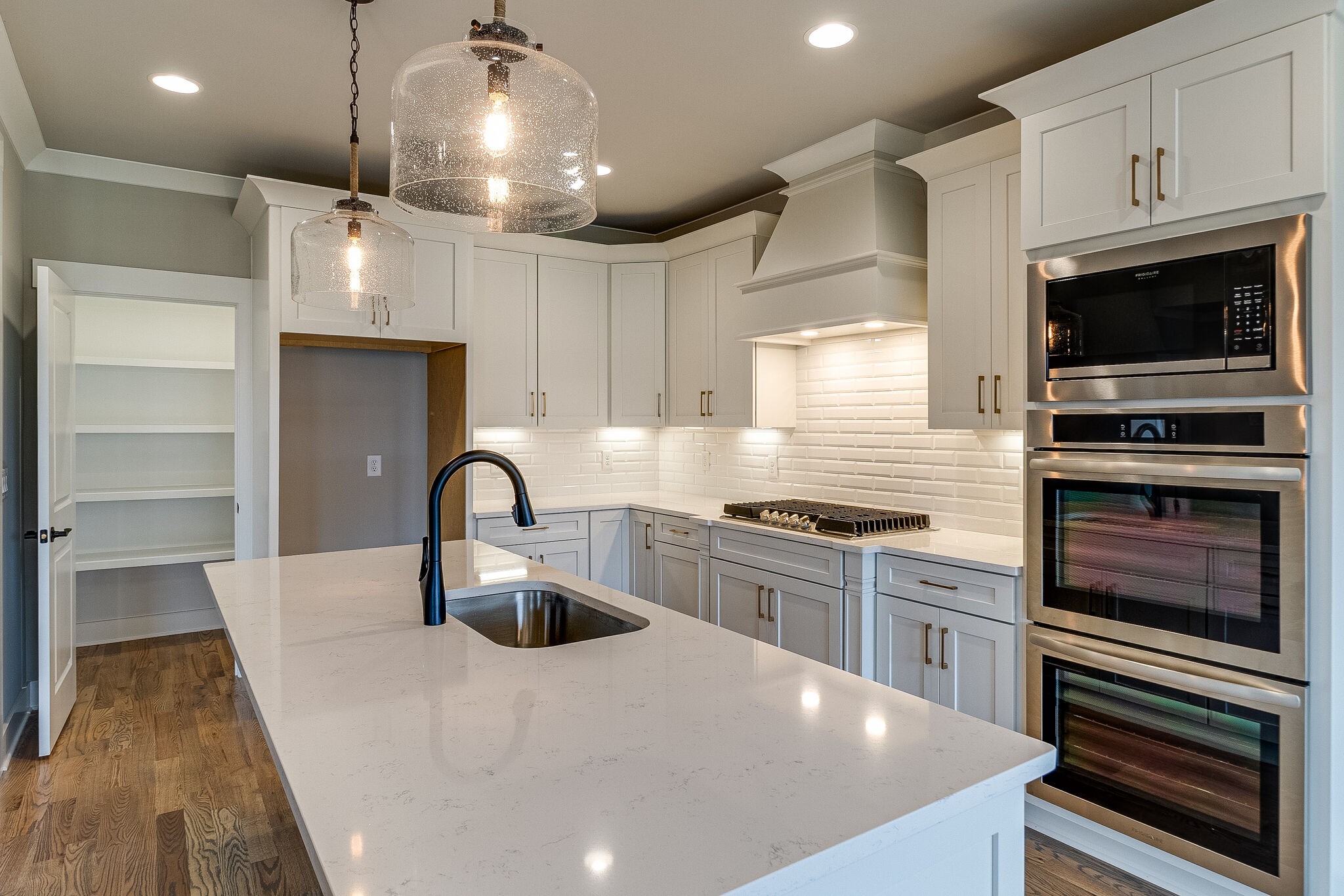 1028 Gadwall Lane Spring Hill, TN 37174 - Photo 19 of 40 a kitchen with kitchen island a stove and a sink