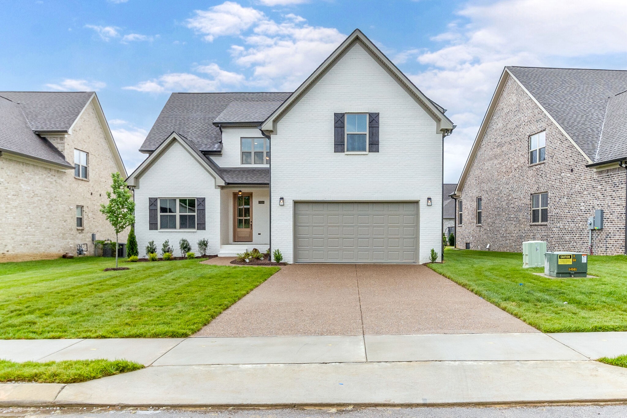 1028 Gadwall Lane Spring Hill, TN 37174 - Photo 2 of 40 a front view of a house with a yard and garage