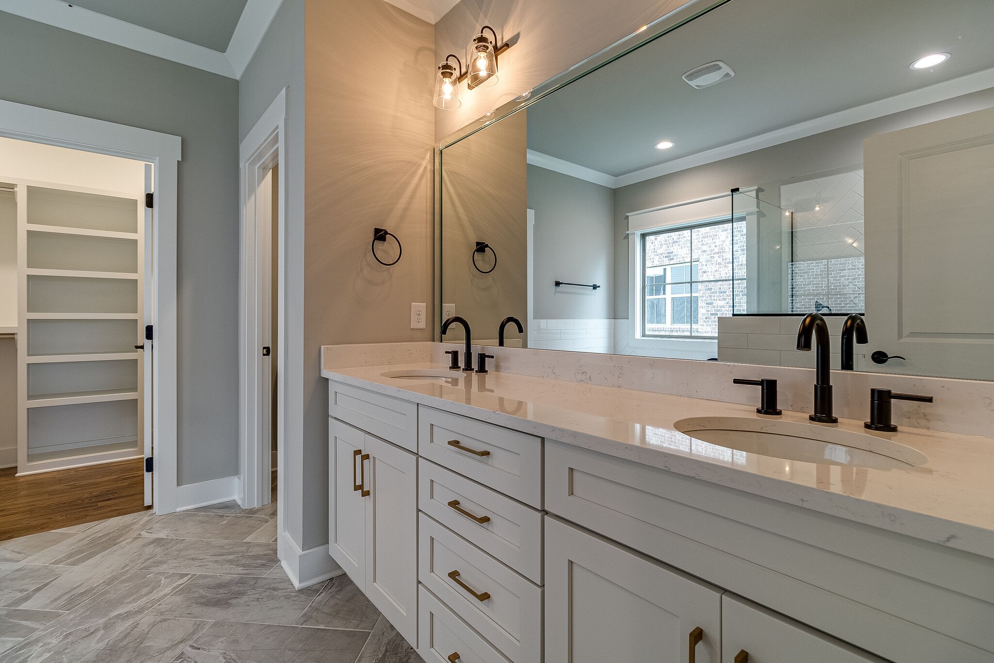 1028 Gadwall Lane Spring Hill, TN 37174 - Photo 22 of 40 a bathroom with double vanity sinks a vanity two mirror and a window