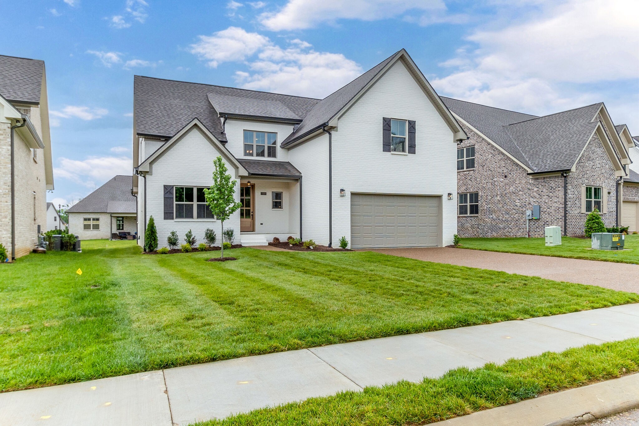 1028 Gadwall Lane Spring Hill, TN 37174 - Photo 4 of 40 a front view of a house with a yard and garage