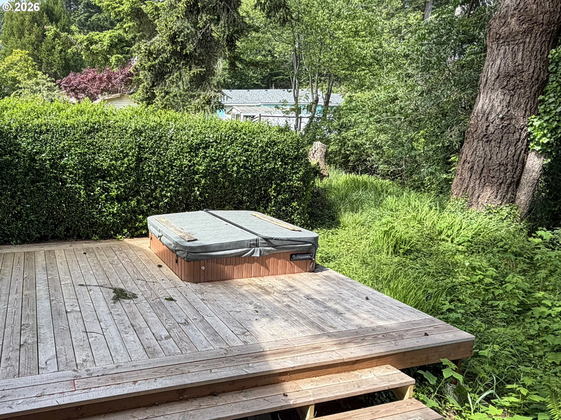 1372 Hampton Road Brookings, OR 97415 - Photo 31 of 42 a view of a patio with table and chairs with wooden floor and fence
