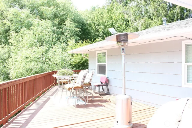 a view of deck with furniture and trees