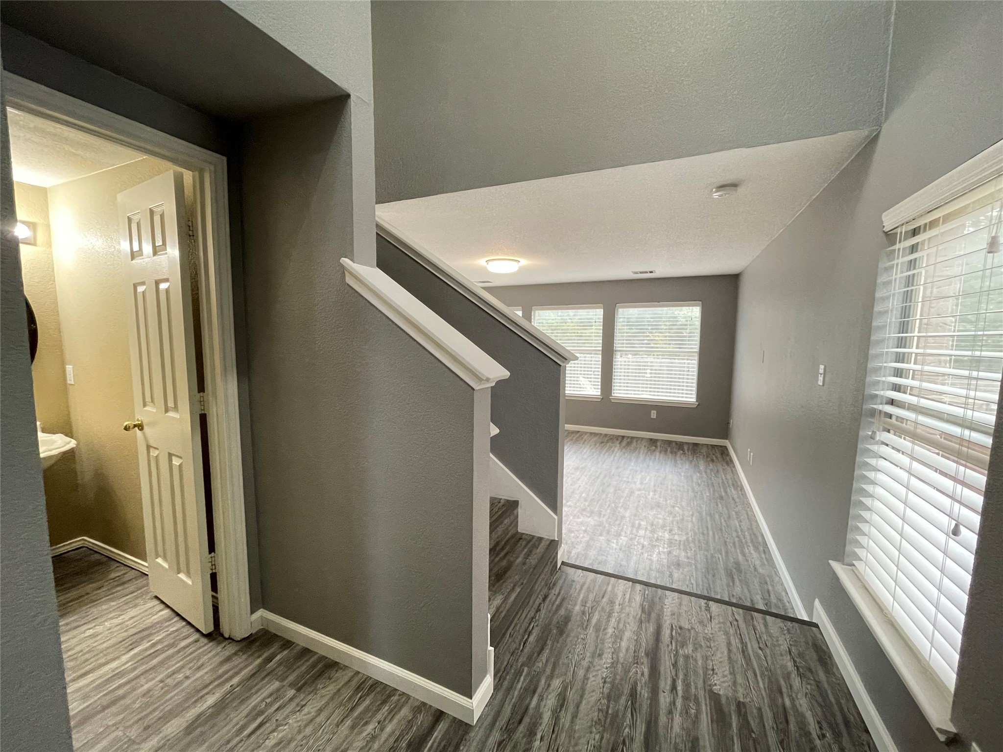 3638 Windhill Loop Round Rock, TX 78681 - Photo 9 of 32 Entryway featuring wood-finish flooring and a staircase with white balusters