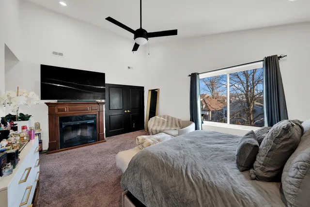 a bedroom with a bed and a fireplace