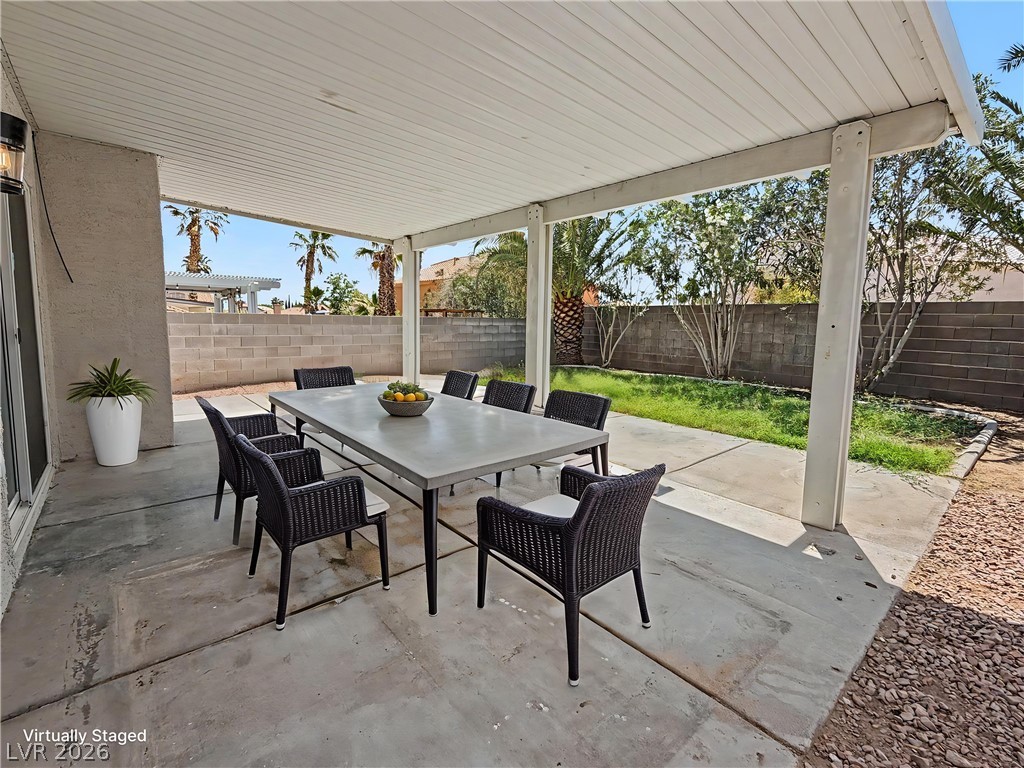 8977 Paige Rene Court Las Vegas, NV 89117 - Photo 24 of 31 An inviting covered patio offers ample space for outdoor dining and enjoyment.