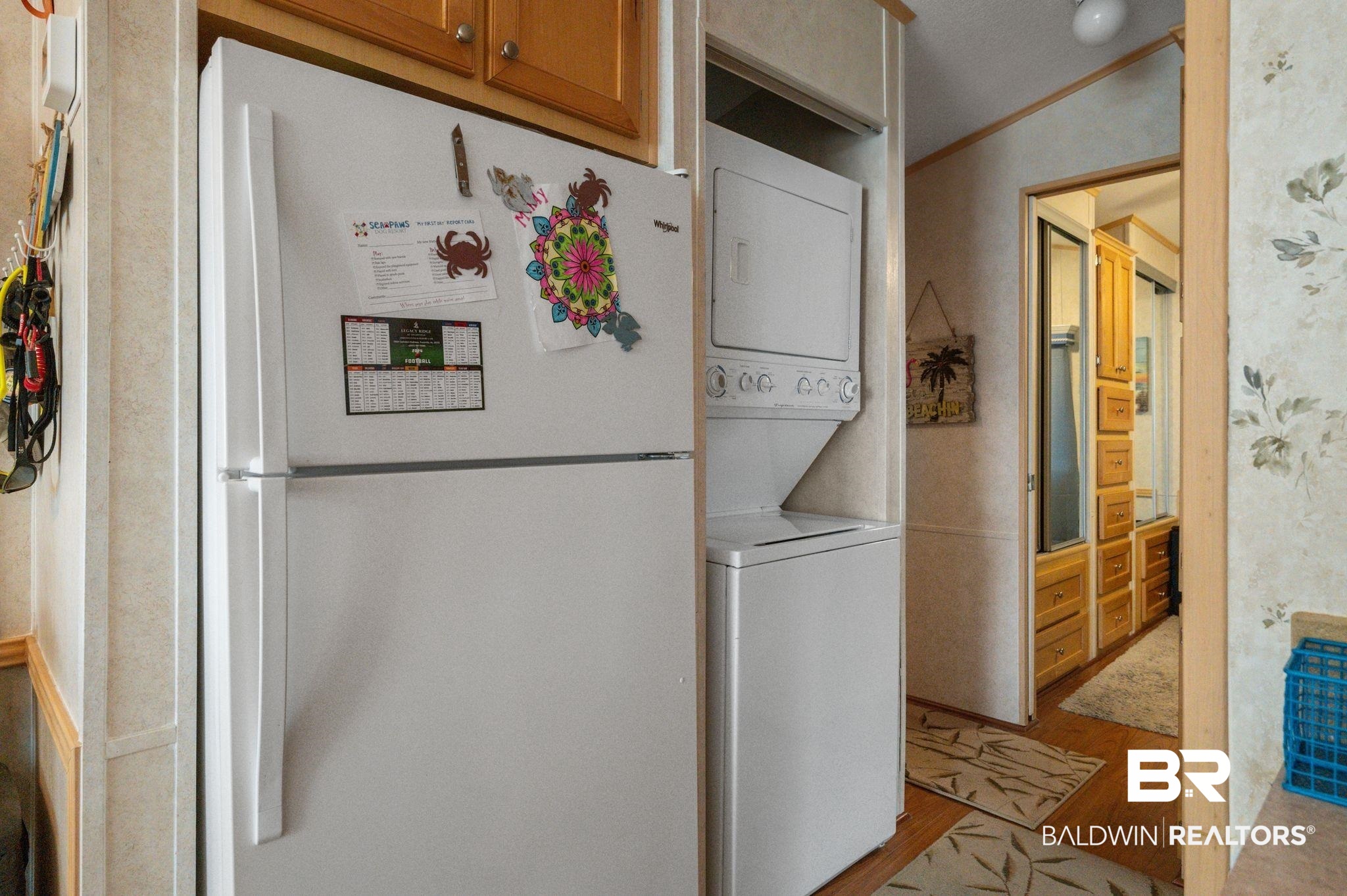 24711 County Road 20, Unit A11 Elberta, AL 36530 - Photo 11 of 35 Laundry area with stacked washer / dryer, light wood-type flooring, and crown molding