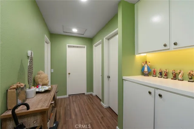 a view of a hallway with workspace and a window