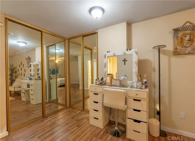 a large bathroom with a glass shower door and a sink