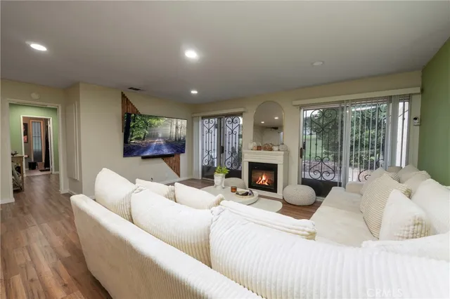 a living room with furniture a large window and a fireplace