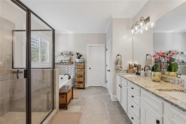 a bathroom with a double vanity sink mirror and shower