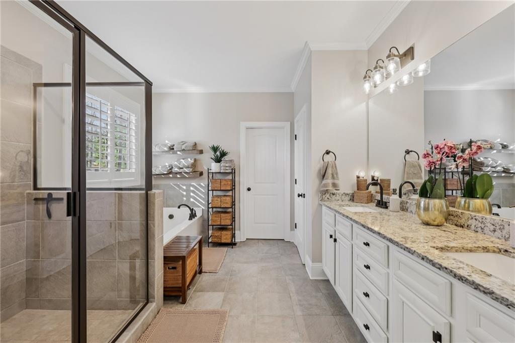 602 Red Leaf Way Canton, GA 30114 - Photo 12 of 40 a bathroom with a double vanity sink mirror and shower