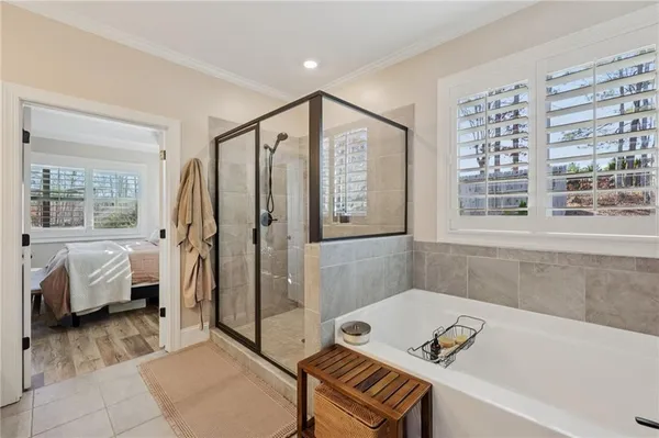 a bathroom with a tub shower and sink