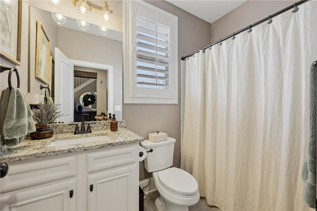 602 Red Leaf Way Canton, GA 30114 - Photo 15 of 40 a bathroom with a granite countertop sink toilet and mirror