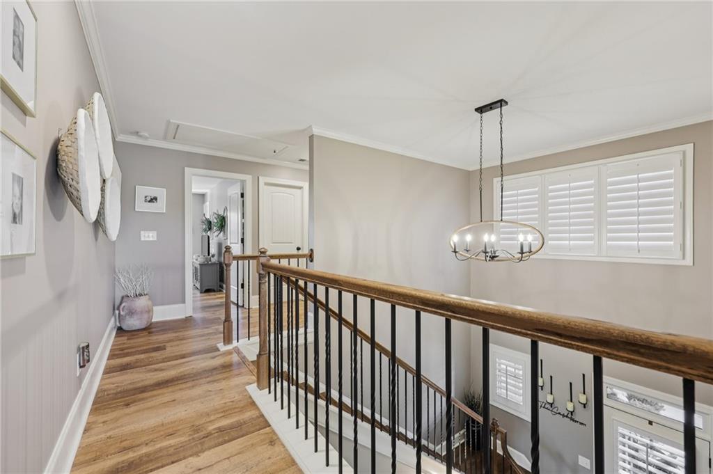 602 Red Leaf Way Canton, GA 30114 - Photo 17 of 40 a view of a hallway with wooden floor and staircase