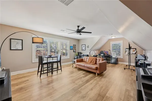 a living room with furniture and wooden floor