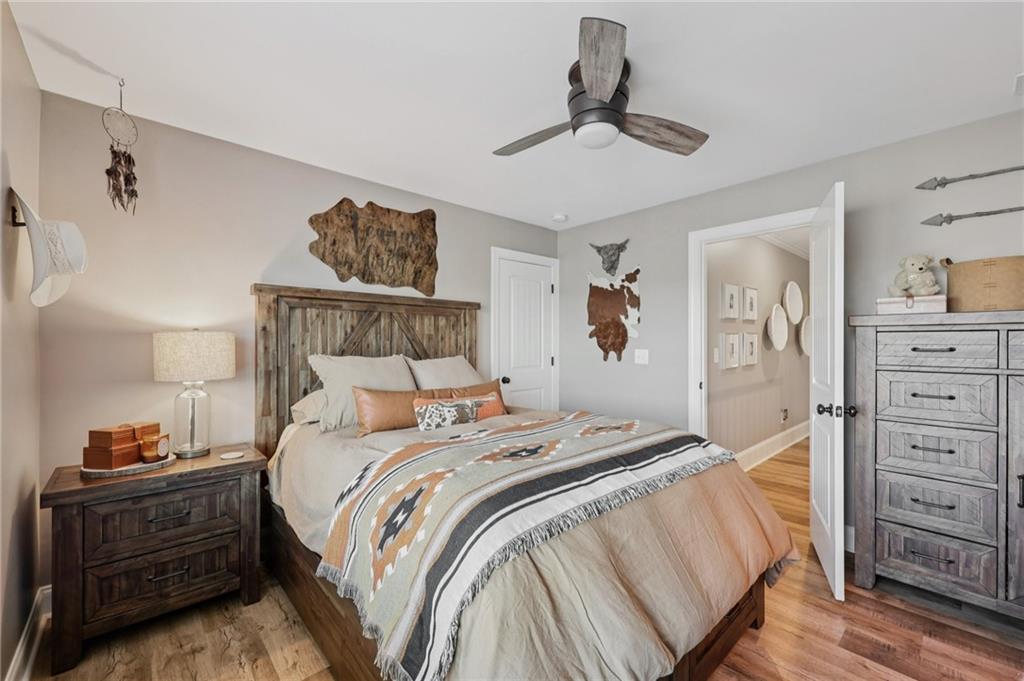 602 Red Leaf Way Canton, GA 30114 - Photo 20 of 40 a bedroom with a bed and wooden floor