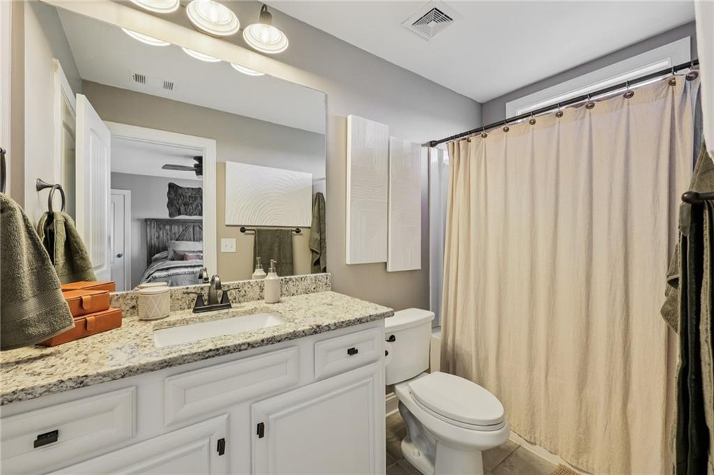 602 Red Leaf Way Canton, GA 30114 - Photo 21 of 40 a bathroom with a granite countertop sink vanity mirror and toilet