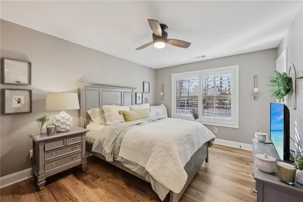 a bedroom with a bed furniture and a flat tv screen