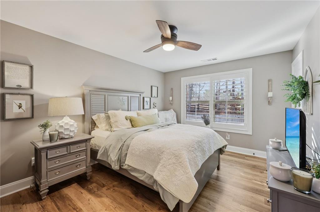 602 Red Leaf Way Canton, GA 30114 - Photo 22 of 40 a bedroom with a bed furniture and a flat tv screen