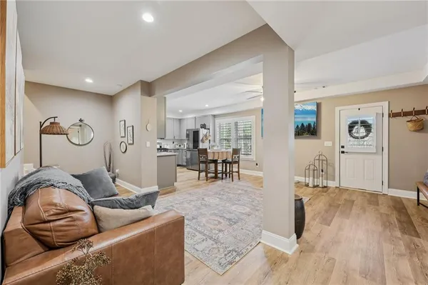 a living room with furniture and a wooden floor