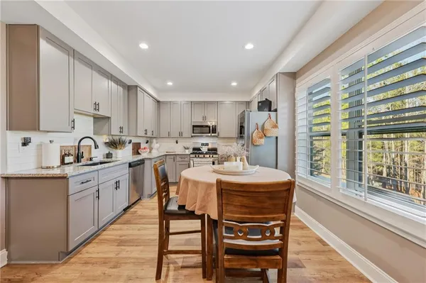 a kitchen with stainless steel appliances granite countertop a stove a sink dishwasher and a refrigerator