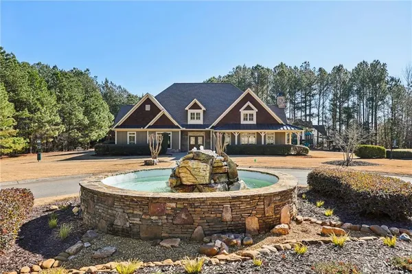 a view of a house with pool fire pit and outdoor space