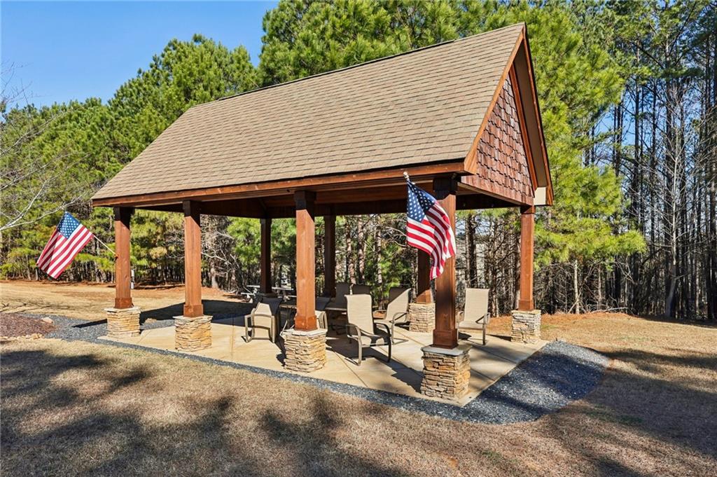 602 Red Leaf Way Canton, GA 30114 - Photo 40 of 40 a view of a patio with a table and chairs under an umbrella with a barbeque