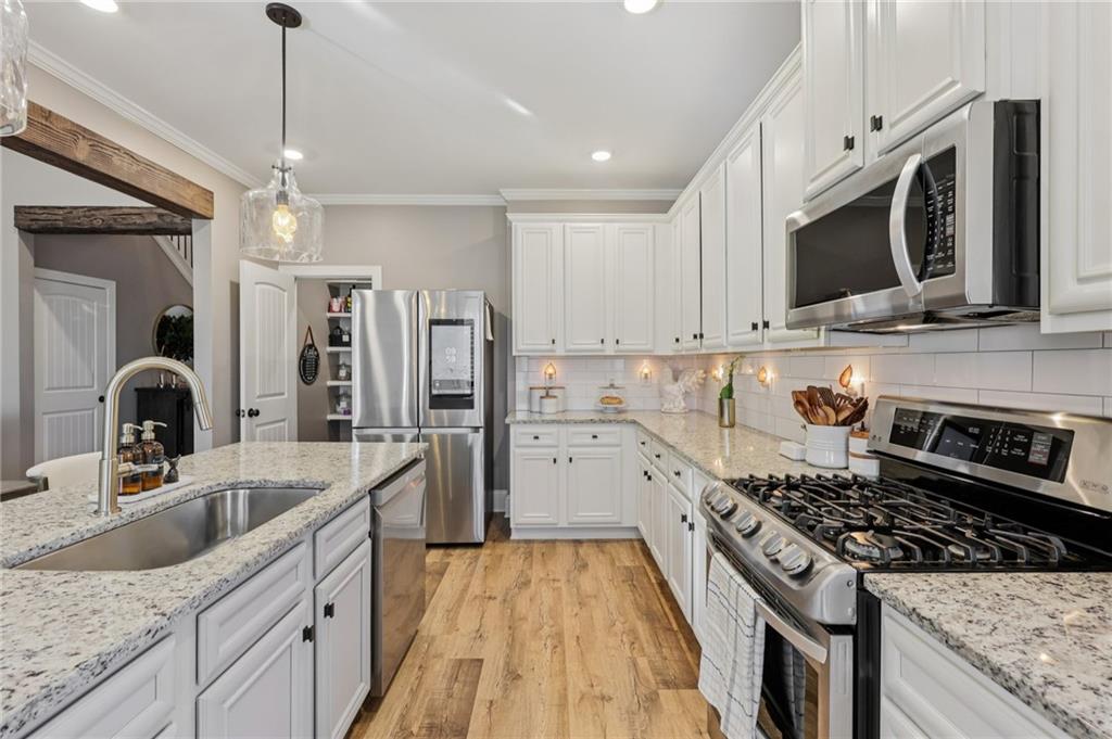 602 Red Leaf Way Canton, GA 30114 - Photo 6 of 40 a kitchen with stainless steel appliances granite countertop a sink stove and refrigerator