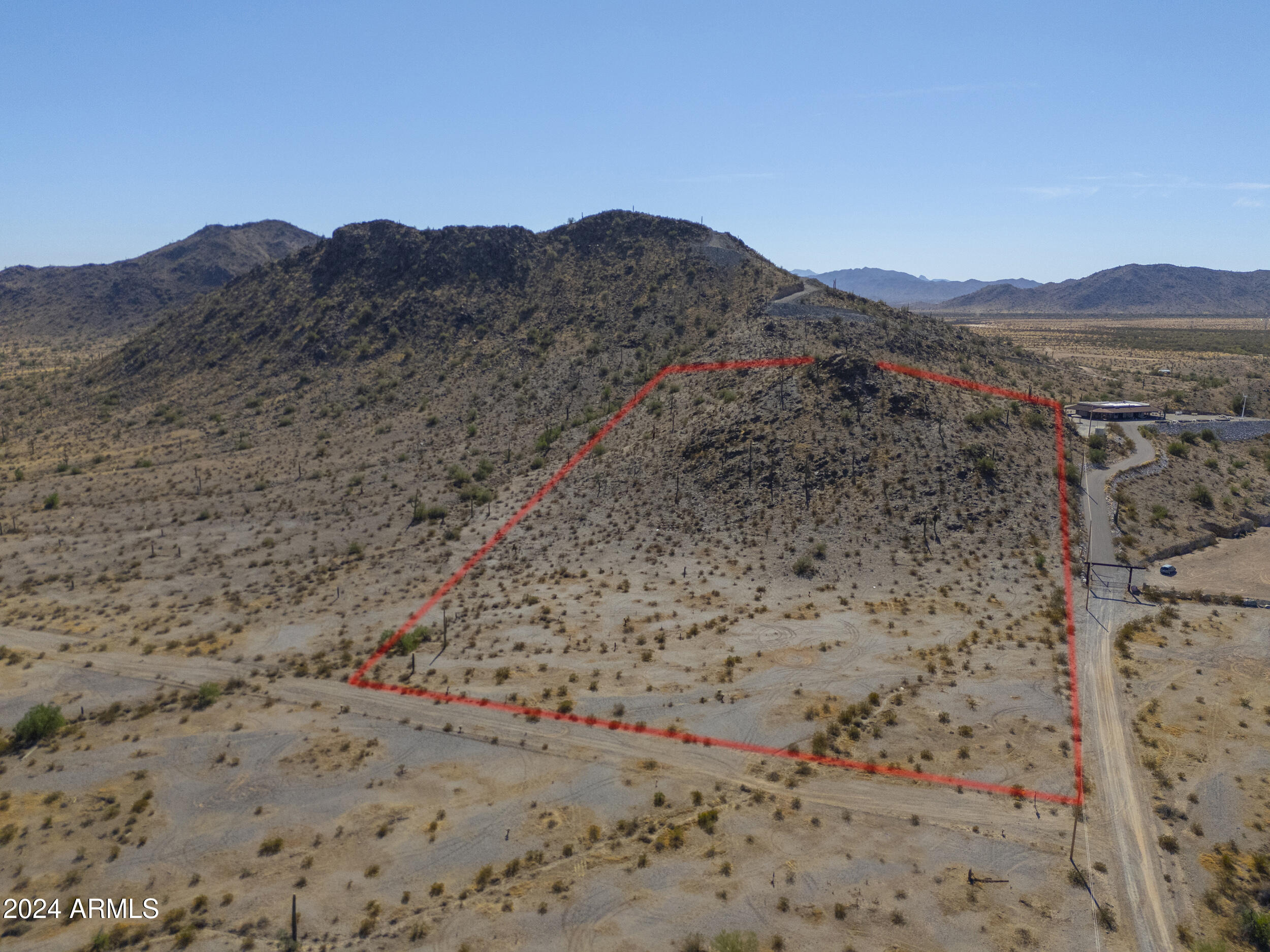 0 West Hilldale Road, Unit 7 Maricopa, AZ 85139 - Photo 1 of 24 a view of a dry field with mountains in the background