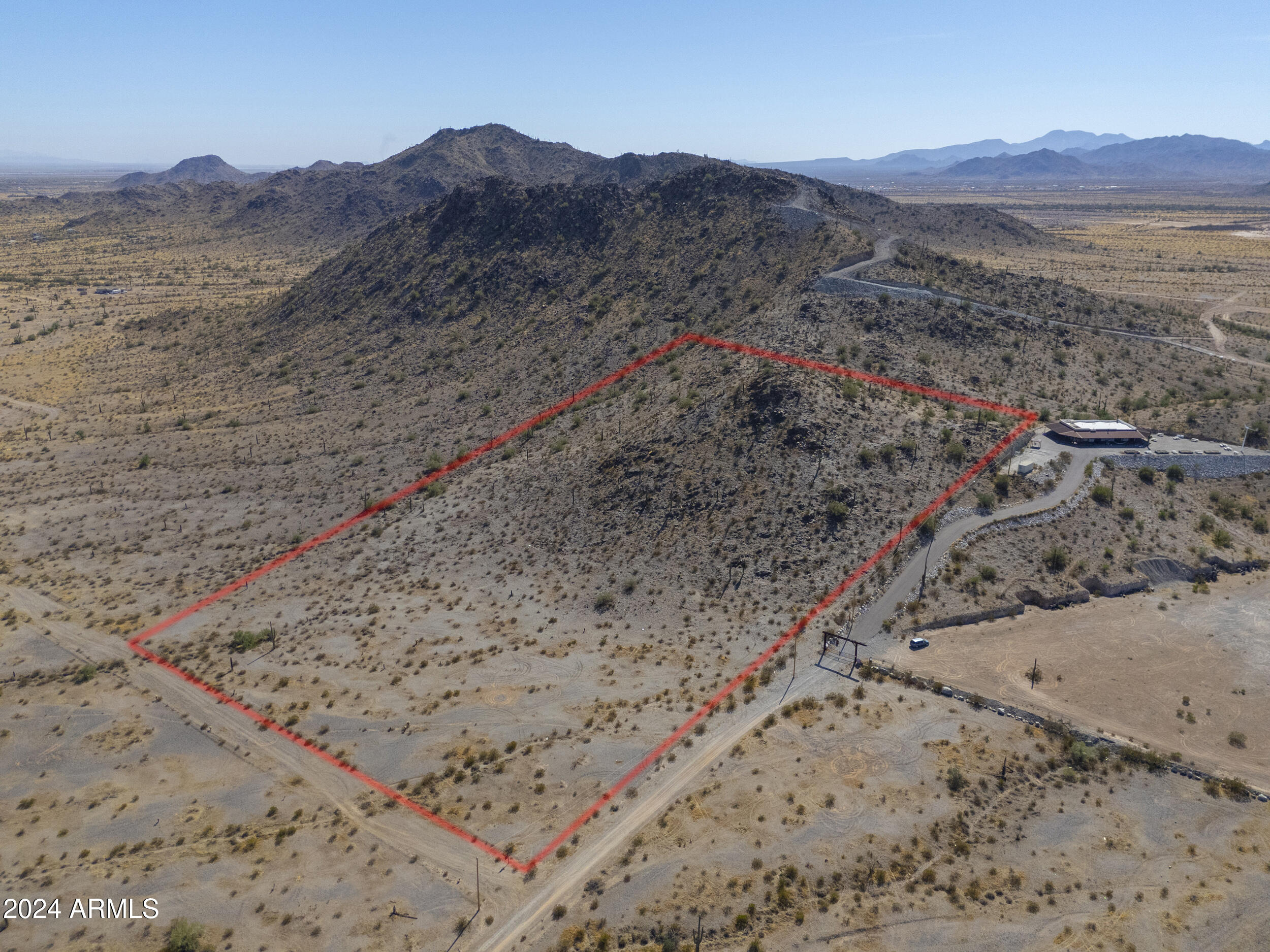 0 West Hilldale Road, Unit 7 Maricopa, AZ 85139 - Photo 11 of 24 a view of a dry field with mountains in the background