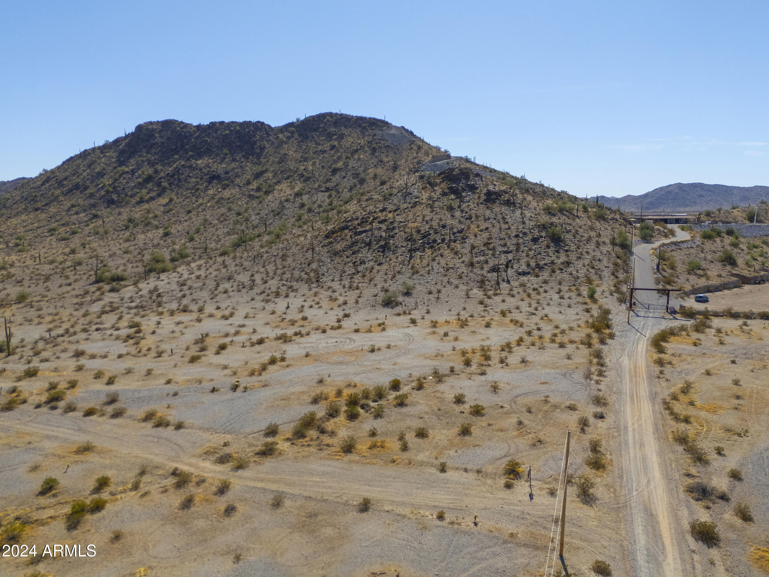0 West Hilldale Road, Unit 7 Maricopa, AZ 85139 - Photo 2 of 24 a view of a dry field with mountains in the background