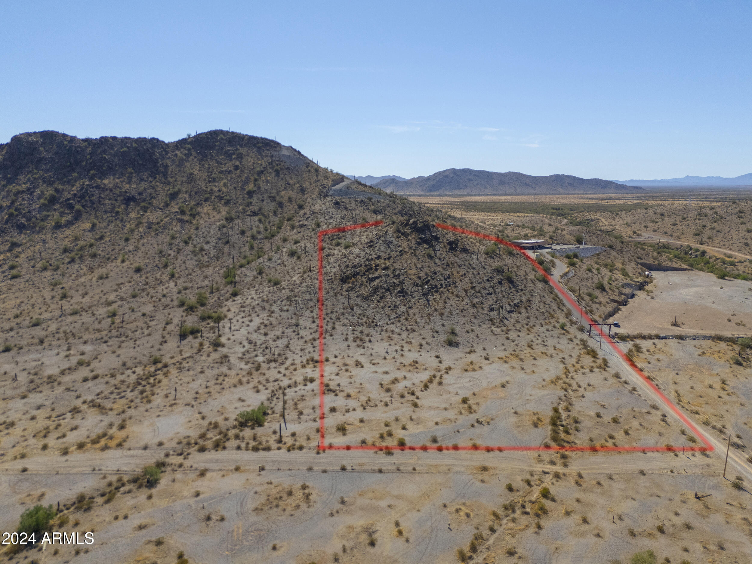 0 West Hilldale Road, Unit 7 Maricopa, AZ 85139 - Photo 4 of 24 a view of a dry field with a mountain in the background