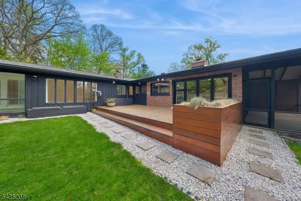a view of a house with backyard and porch