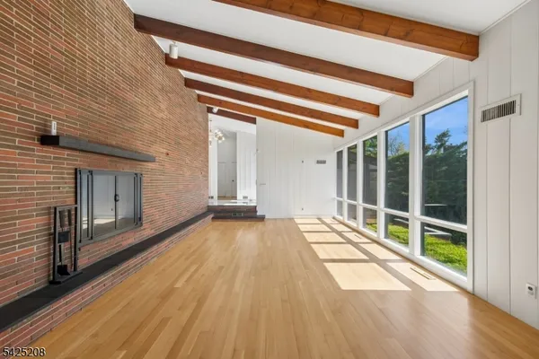 a view of a porch with a floor to ceiling window and outside view