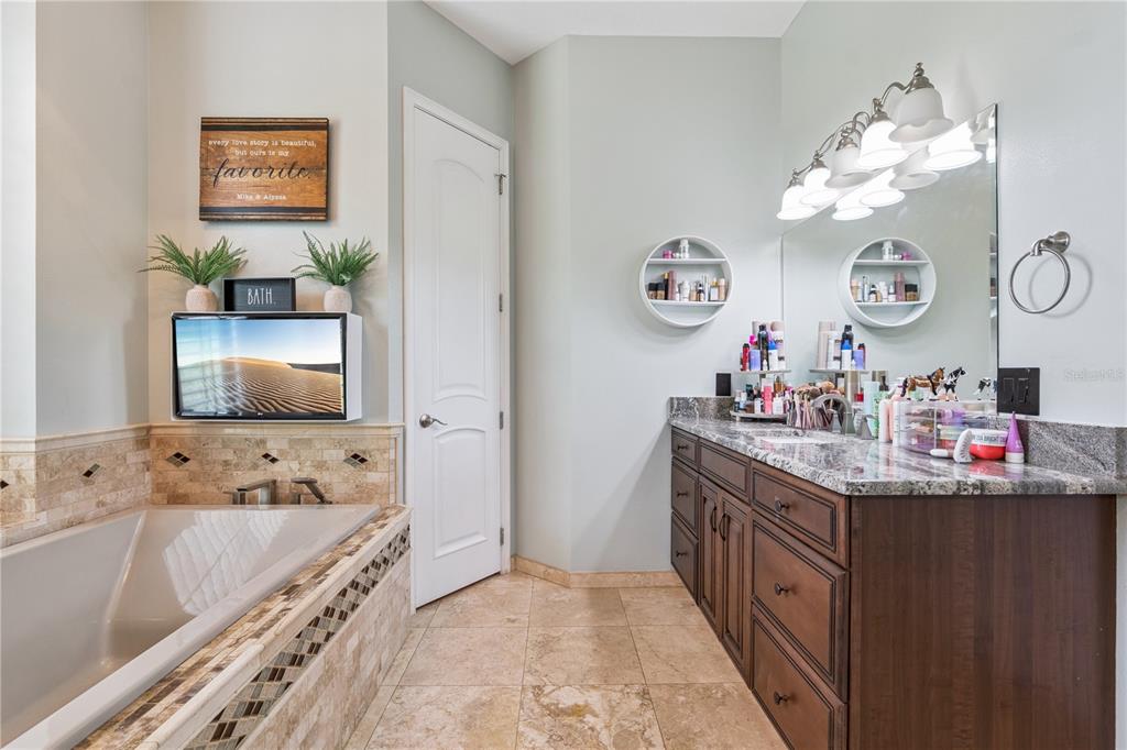 345 Cypress Isles Road Osteen, FL 32764 - Photo 14 of 41 a very nice looking room with a large mirror and a sink