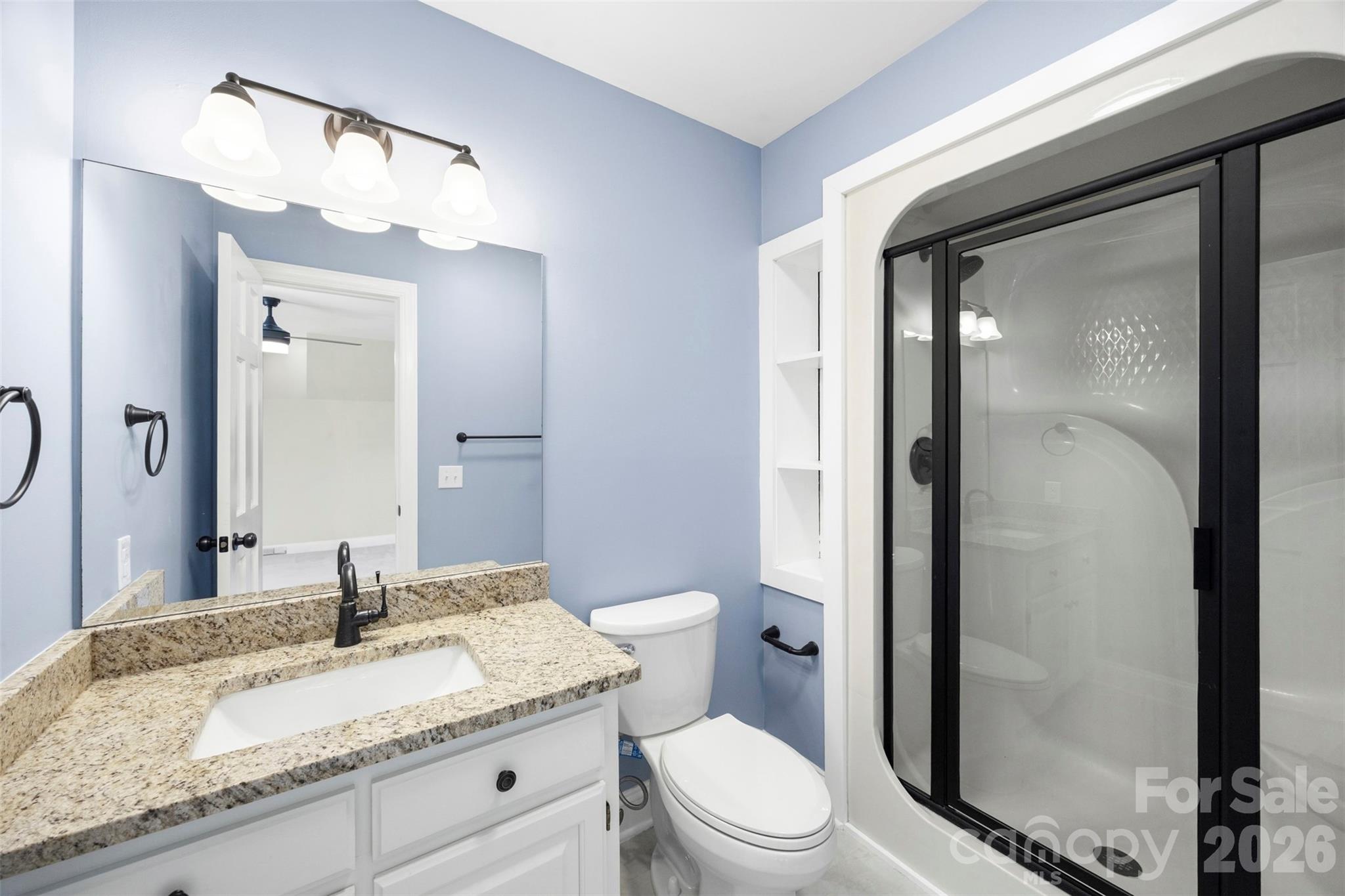 813 Rothmoor Drive Northeast Concord, NC 28025 - Photo 17 of 35 a bathroom with a granite countertop sink mirror vanity and toilet