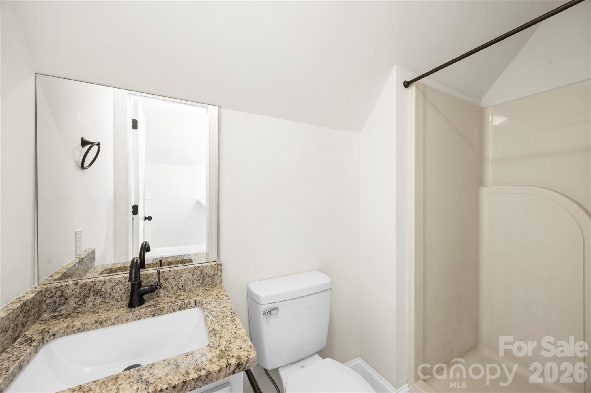 813 Rothmoor Drive Northeast Concord, NC 28025 - Photo 21 of 35 a bathroom with a granite countertop sink a mirror and a toilet