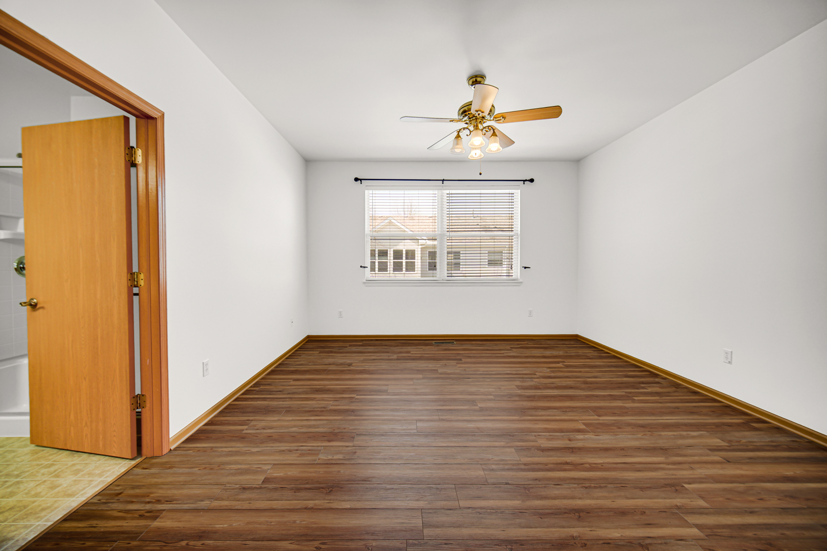 690 Wellston Lane Romeoville, IL 60446 - Photo 11 of 22 a view of an empty room with wooden floor and a window