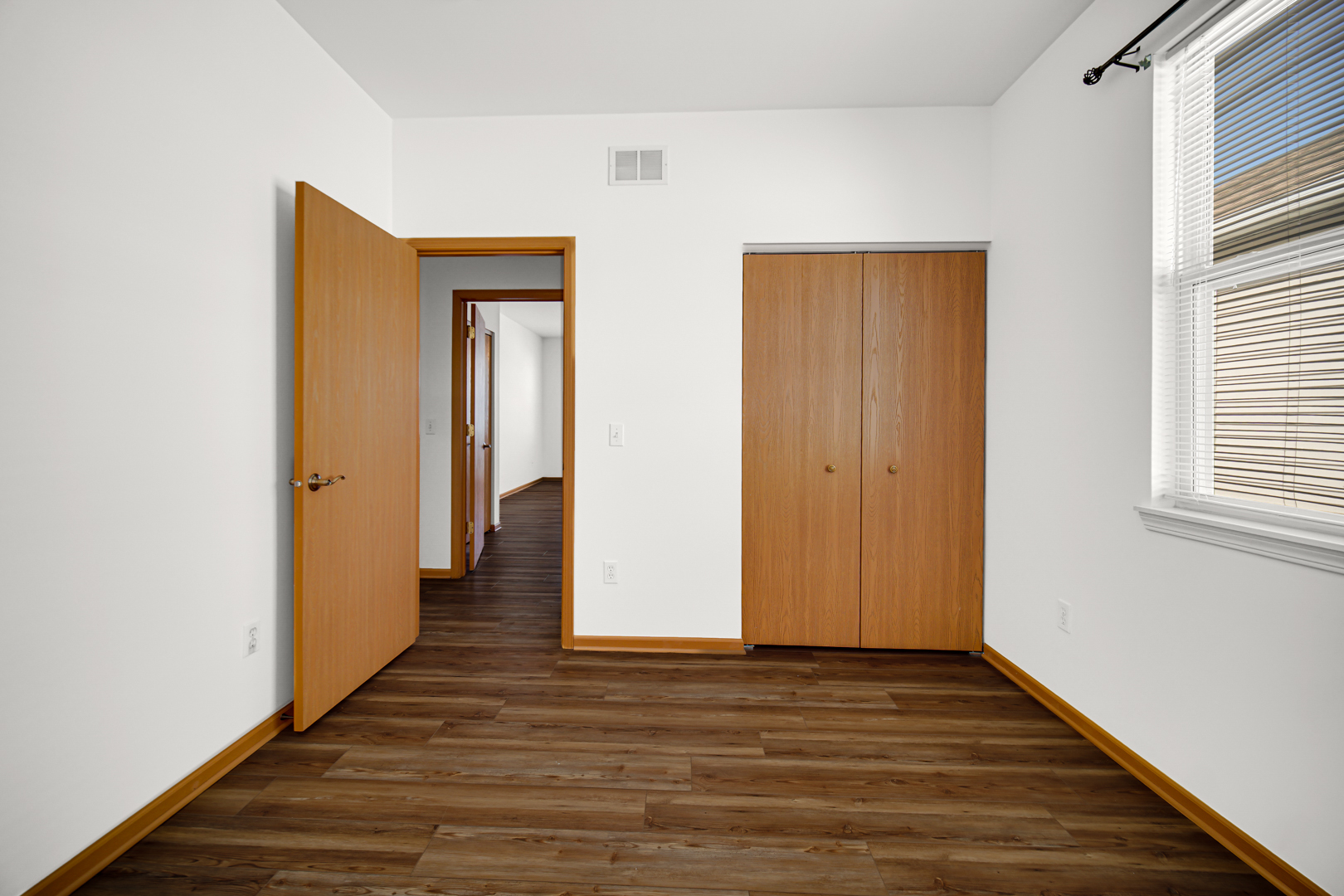 690 Wellston Lane Romeoville, IL 60446 - Photo 16 of 22 a view of a hallway with wooden floor