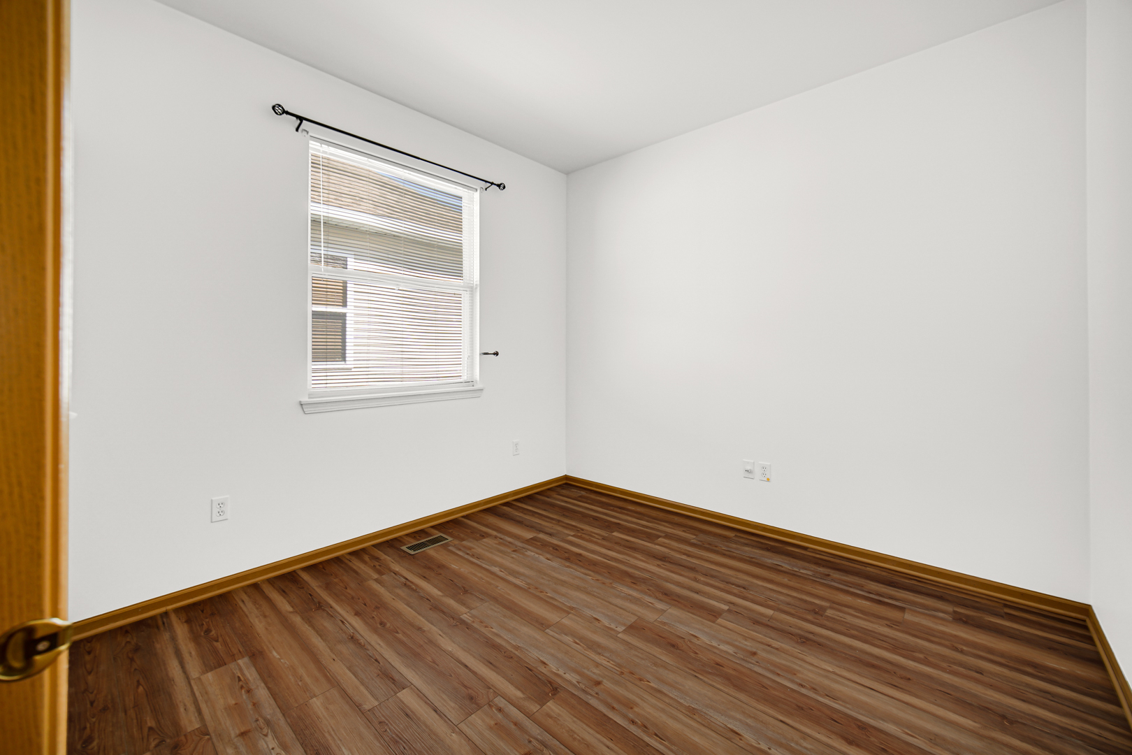 690 Wellston Lane Romeoville, IL 60446 - Photo 17 of 22 an empty room with wooden floor and windows