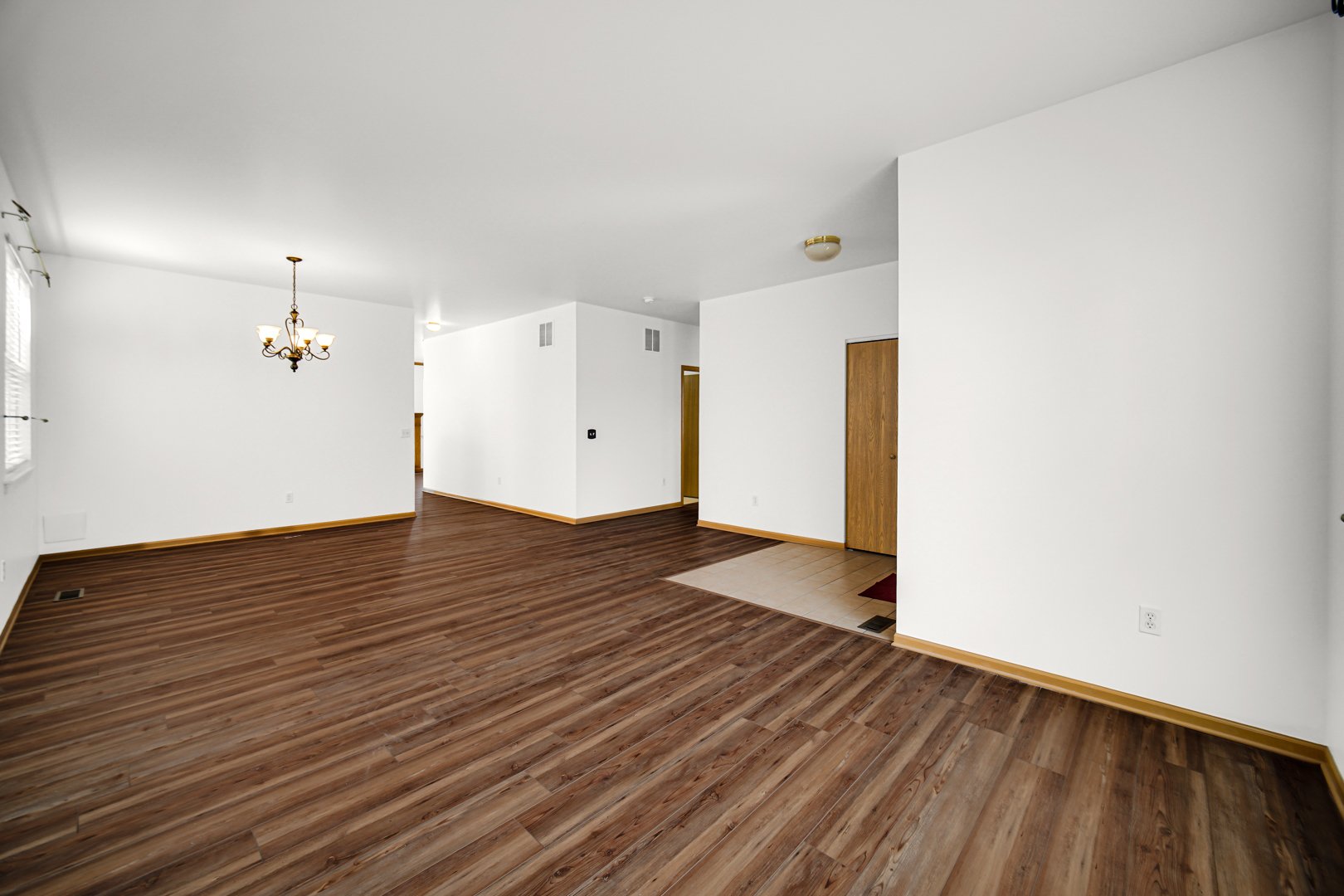 690 Wellston Lane Romeoville, IL 60446 - Photo 3 of 22 a view of a room with wooden floor