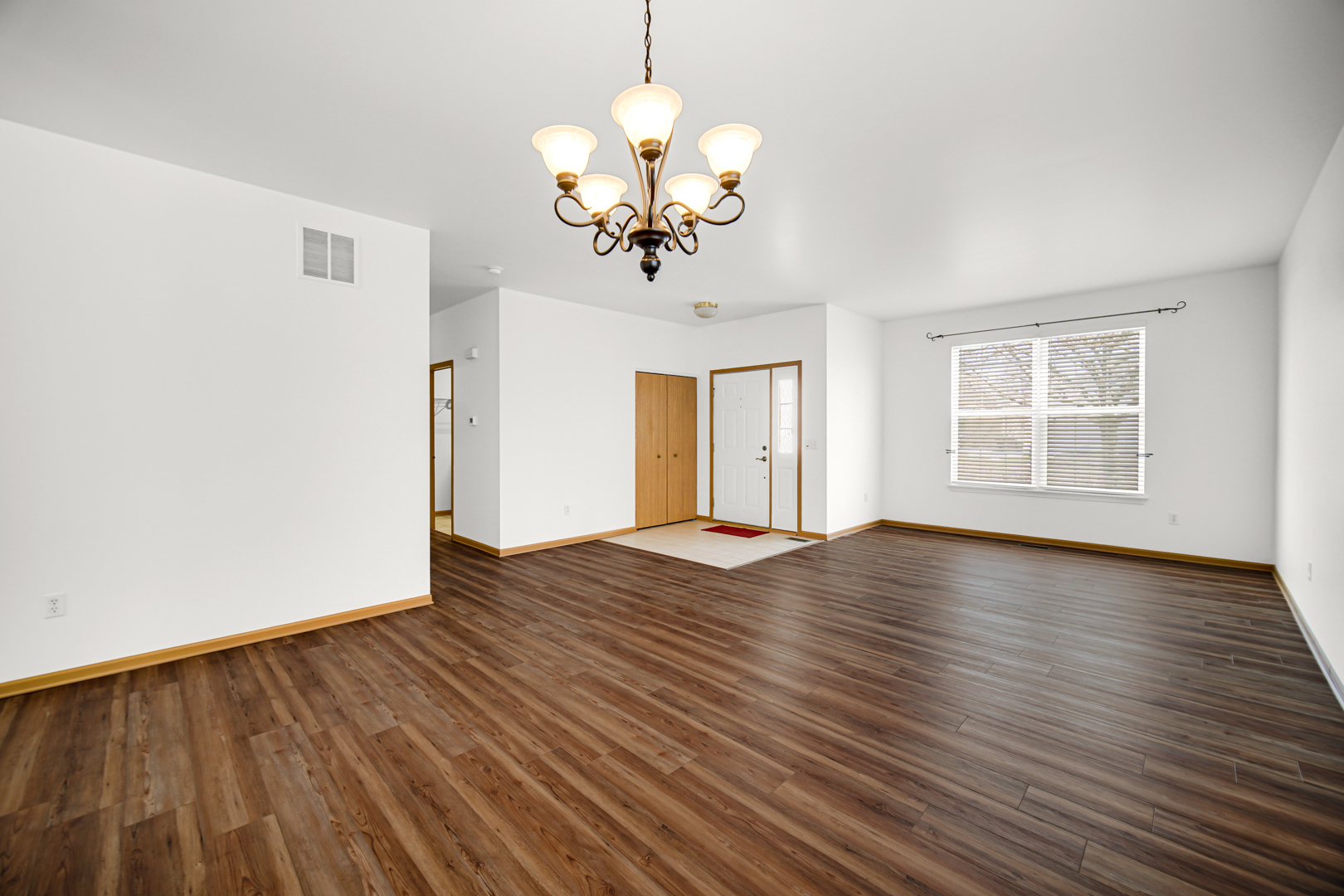 690 Wellston Lane Romeoville, IL 60446 - Photo 4 of 22 a view of an empty room with wooden floor and a window